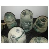 12 green glass insulators