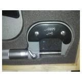 3 micrometers set in wood case.