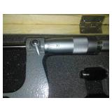 3 micrometers set in wood case.