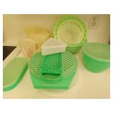 Collection OF Green Tupperware And Three Measuring Cups