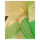 Collection OF Green Tupperware And Three Measuring Cups