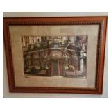 Framed print of a corner café with blooming flowers
