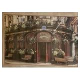 Framed print of a corner café with blooming flowers