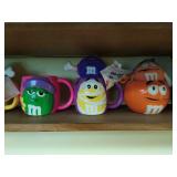 Collection of M & M cups with plush toys