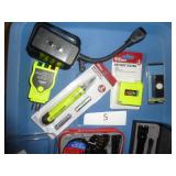 wire stripping electrical kit, metal flashlight, battery tester, and chirper and outlet tester and remote control