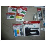lot of staple guns (untested), bunch of staples, storage net