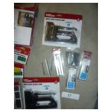 lot of staple guns (untested), bunch of staples, storage net