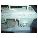 working Singer sewing machine with various stitches, a container full of buttons sorted by color, and a play holly hobbie sewing machine