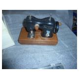 working Singer sewing machine with various stitches, a container full of buttons sorted by color, and a play holly hobbie sewing machine