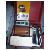 Old Kodak instant camera and a 35mm SLR with nice leather case