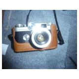 Old Kodak instant camera and a 35mm SLR with nice leather case