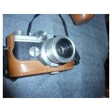 Old Kodak instant camera and a 35mm SLR with nice leather case