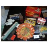 misc collection of vintage items, cardboard serving plate, hair nets, toothpick angels for cake decorating I assume, old sunbeam iron box, slide rule, baby shoes, and a mustimeter