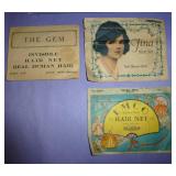 misc collection of vintage items, cardboard serving plate, hair nets, toothpick angels for cake decorating I assume, old sunbeam iron box, slide rule, baby shoes, and a mustimeter