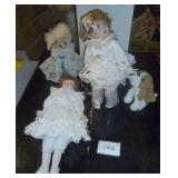 New in box porcelain doll with her dog pulling on her dress, another porcelain doll and a bear with lace dress