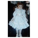 New in box porcelain doll with her dog pulling on her dress, another porcelain doll and a bear with lace dress