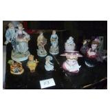 group of figures including a head vase and hummel