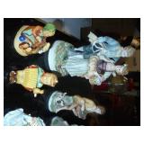 group of figures including a head vase and hummel