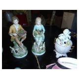 group of figures including a head vase and hummel