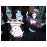 group of figures including a head vase and hummel