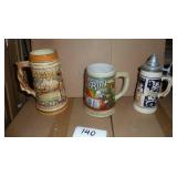 3 Steins in great condition, South Dakota Badlands and Mount Rushmore, Budweiser St Patricks Day and a German lidded stein