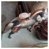 Box containing a brass horse statue...