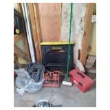 2 saw horses, bin of tools, and emp...