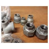 Lot of (48) Steel Pipe Fittings - (24) 1" Plugs, (2) 3/4" Street Elbows, (13) 1" Bushings, (7) 1" x 1" x 1/2" Tees, (2) 1" Unions
