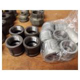 Lot of (39) Steel Pipe Fittings - (11) 1-1/4" Couplers, (2) 1-1/4" Unions, (6) 1-1/4" x 1" Reducers, (2) 1-1/4" x 1/2" Reducers, (5) 1-1/4" Plugs, (9) 1-1/4" Caps, (4) 1-1/2" Plugs