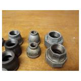 Lot of (39) Steel Pipe Fittings - (11) 1-1/4" Couplers, (2) 1-1/4" Unions, (6) 1-1/4" x 1" Reducers, (2) 1-1/4" x 1/2" Reducers, (5) 1-1/4" Plugs, (9) 1-1/4" Caps, (4) 1-1/2" Plugs