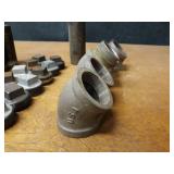Lot of (35) Steel Pipe Fittings - (12) 2" Plugs, (5) 2" 45° Elbows, (6) 2" x 5-1/2" Nipples, (4) 2" x 4-1/2" Nipples, (2) 2" x 4" Nipples, (3) 2" x 5" Nipples, (2) 2" x 6" Nipples & (1) 2" x 10" Nipp