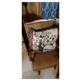 Household Furniture group to include a uniquely crafted 4 tier wood corner shelf/plant stand with a Wood framed and cushioned glider Rocker and decorative display pillow embroidered to show a birdhous