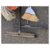 Lot of Cleaning Tools: Brooms, Mops, And More.