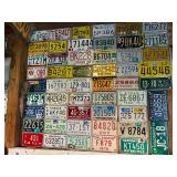 Board Full of Motorcycle License Plates from Assorted States