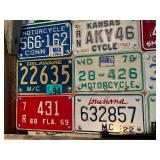 Board Full of Motorcycle License Plates from Assorted States