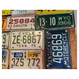 Board Full of Motorcycle License Plates from Assorted States