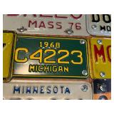 Board Full of Motorcycle License Plates from Assorted States