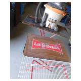 Rigid shop vacuum and 3 Little Debbie display tables