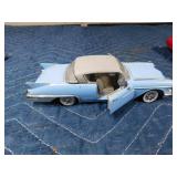 2 die cast cars and 1 tin car