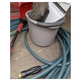 A Variety of Cleaning Tools Including Rakes, Garden Hose, Snow Shovel and More