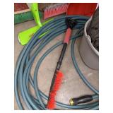 A Variety of Cleaning Tools Including Rakes, Garden Hose, Snow Shovel and More