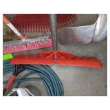 A Variety of Cleaning Tools Including Rakes, Garden Hose, Snow Shovel and More