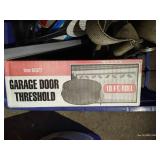 Crate With Digital Angle Finder, New Garage Door Threshold, Spray Foam, Tie Down Strap, And Other Misc.