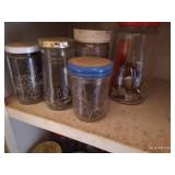 White Cabinet With Several Hardware Jars Inside