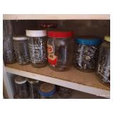 White Cabinet With Several Hardware Jars Inside