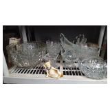 Shelf full of crystal and glassware and figurine