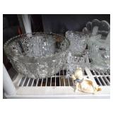 Shelf full of crystal and glassware and figurine