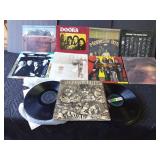 Rock and roll LP records and 2 stacks of various artists out of their sleeves