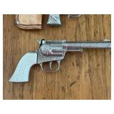 Vintage Toy Western Cowboy Holster with Hubley Toy Rodeo Star Cap Gun, Hubley Toy Star Cap Gun, and Kit Carson Toy Cap Guns