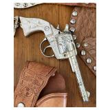 Vintage Toy Western Cowboy Holster with Hubley Toy Rodeo Star Cap Gun, Hubley Toy Star Cap Gun, and Kit Carson Toy Cap Guns